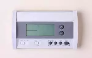 digital wall-mounted thermostat with button controls