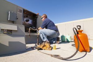 technician repairs cooling system on casino rooftop