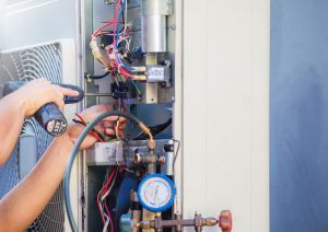 technician repairs heating unit