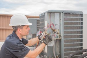 hvac technician installs new commercial unit