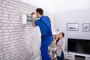 technician-replaces-residential-ac-unit