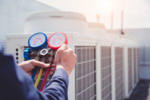 technician-checking-air-conditioner-measuring-equipment