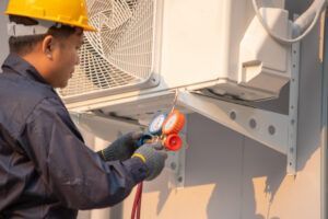 technician checking outdoor air conditioner