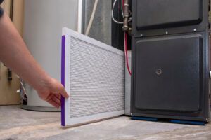 person changing clean air filter