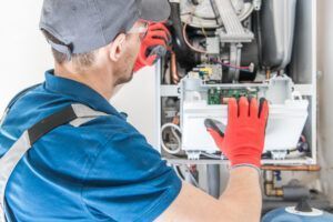 echnician working on gas furnace