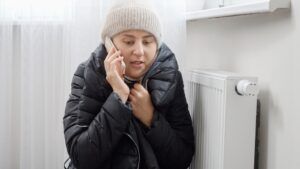 A cold woman sitting by her heater wondering if furnace tune-ups are really necessary in Arizona.
